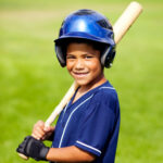A young boy plays his favorite sport, baseball.